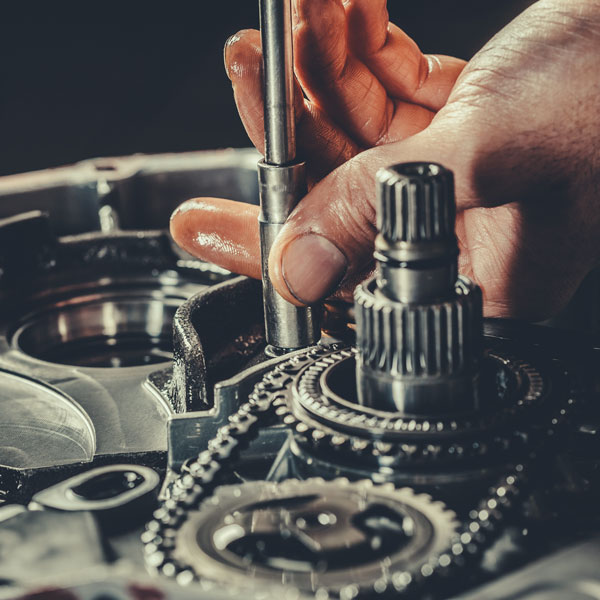 mechanic tightening bolt on gears
